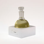 TUCKSON london Glassine Eau de Parfum 150 ml  flagship flask resting on a handmade white porcelain square base labelled Psidium
