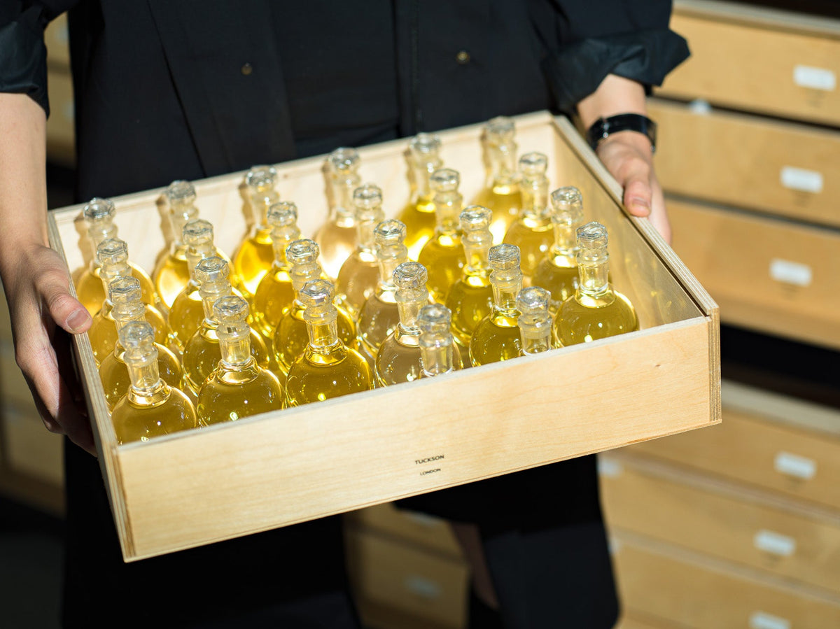 Tuckson perfumer in his Greenwich London workshop preparing hand poured perfume for packing and shipping.